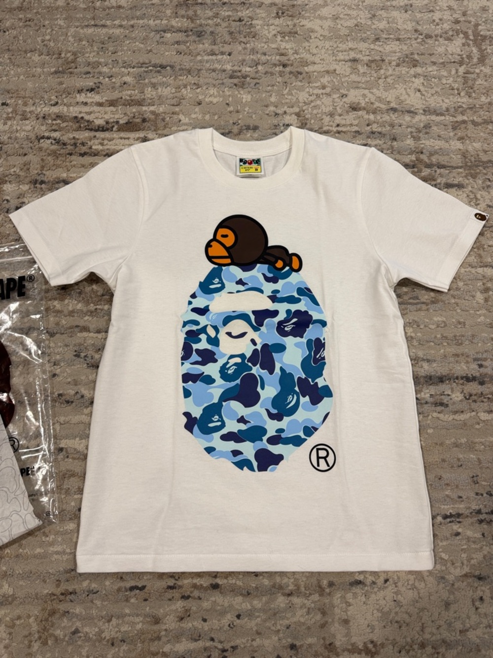 A Bathing Ape White Short Sleeve Tee with Signature Ape Graphic